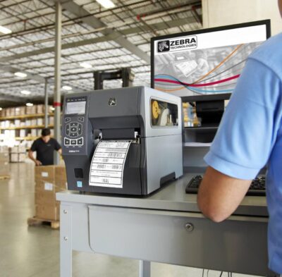 Zebra zt411 label printer in a warehouse setting, printing labels for logistics and inventory management