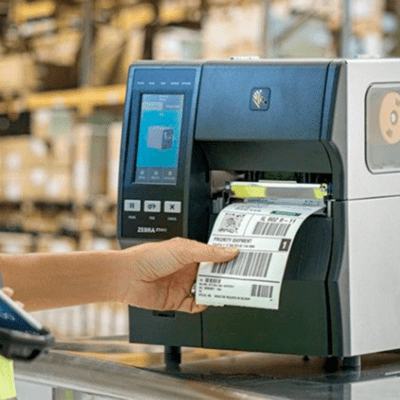 Zebra zt411 label printer in a warehouse setting, printing labels for logistics and inventory management