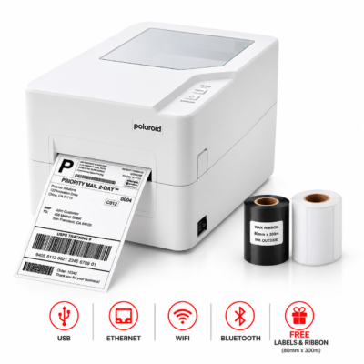 Polaroid label printer with printed shipping label, plus black and white label rolls nearby.