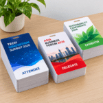 Three conference badges on a wooden desk Attendee for Tech Innovation Summit 2026 Delegate for Asia Business Forum 2026 and Exhibitor for Sustainability Conference 2026 A plant sits in the background